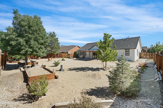 169 Oakridge Dr, Dayton, NV 89403 - back of house with a garden, a fenced backyard, stucco siding, and a patio area
