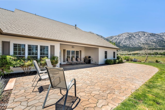 600 Artemesia Ln, Gardnerville, NV 89460 - rear view of property with a patio area, a mountain view, and roof with shingles