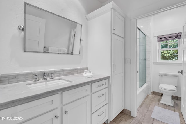 600 Artemesia Ln, Gardnerville, NV 89460 - full bath with vanity, shower / bath combination with glass door, and wood finished floors