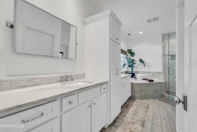 600 Artemesia Ln, Gardnerville, NV 89460 - bathroom featuring vanity, a stall shower, a bath, and recessed lighting