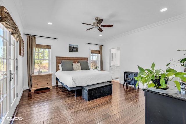 600 Artemesia Ln, Gardnerville, NV 89460 - bedroom with multiple windows, a wood stove, wood finished floors, crown molding, and recessed lighting