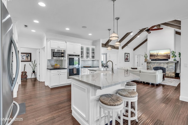 600 Artemesia Ln, Gardnerville, NV 89460 - kitchen featuring stainless steel appliances, recessed lighting, open floor plan, glass insert cabinets, and a breakfast bar