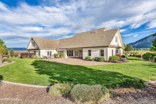 600 Artemesia Ln, Gardnerville, NV 89460 - rear view of property with french doors, a lawn, a patio, a mountain view, and a shingled roof