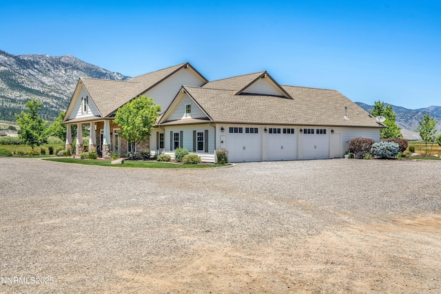 600 Artemesia Ln, Gardnerville, NV 89460 - view of front facade featuring gravel driveway, a mountain view, an attached garage, and a shingled roof