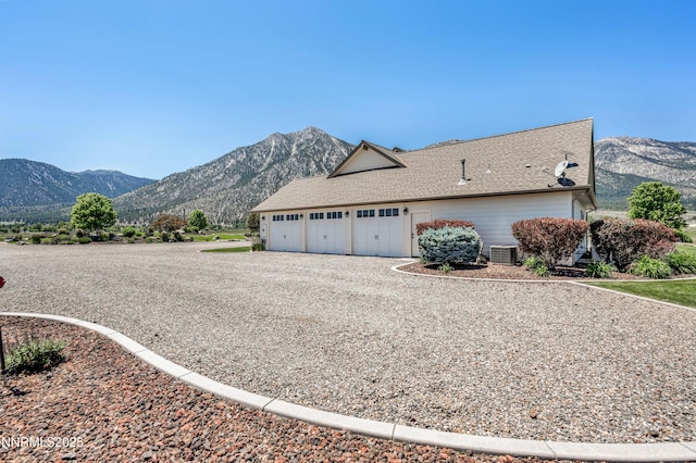 600 Artemesia Ln, Gardnerville, NV 89460 - view of side of home featuring a mountain view, gravel driveway, and an attached garage