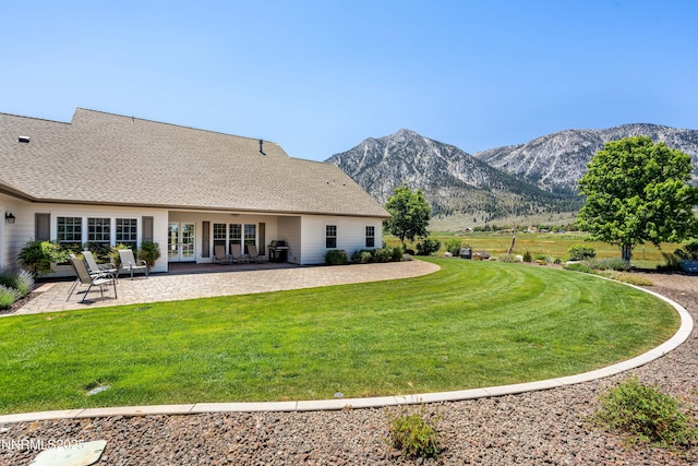 600 Artemesia Ln, Gardnerville, NV 89460 - rear view of property featuring a mountain view, french doors, a lawn, and a patio area