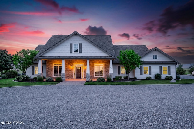 600 Artemesia Ln, Gardnerville, NV 89460 - view of front facade with a lawn, covered porch, a shingled roof, and stone siding
