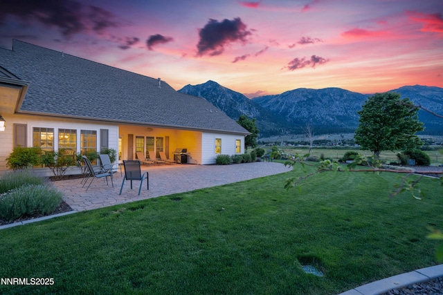 600 Artemesia Ln, Gardnerville, NV 89460 - yard at dusk with a lawn, a patio, and a mountain view