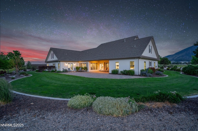 600 Artemesia Ln, Gardnerville, NV 89460 - back of property at dusk with a yard