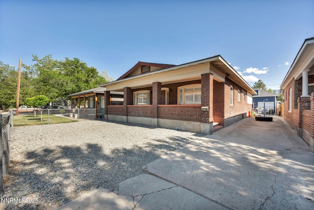 911 F St, Sparks, NV 89431 - view of side of home featuring brick siding, a porch, and concrete driveway