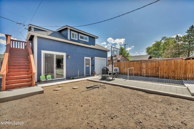 911 F St, Sparks, NV 89431 - rear view of property featuring stairway, a patio, and a garage