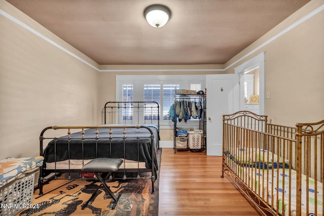 911 F St, Sparks, NV 89431 - bedroom with wood finished floors, a textured ceiling, and crown molding