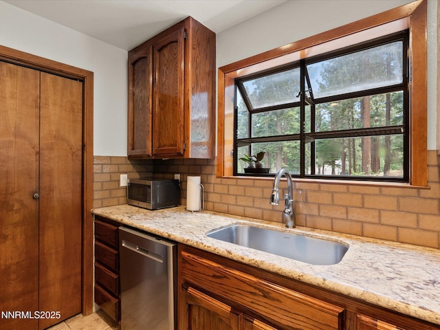139 Rosewood Cir, Stateline, NV 89449 - kitchen featuring appliances with stainless steel finishes, light stone countertops, tasteful backsplash, and healthy amount of natural light