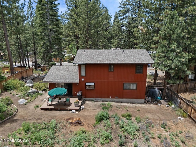 139 Rosewood Cir, Stateline, NV 89449 - back of property with a wooden deck, a shingled roof, and a fenced backyard