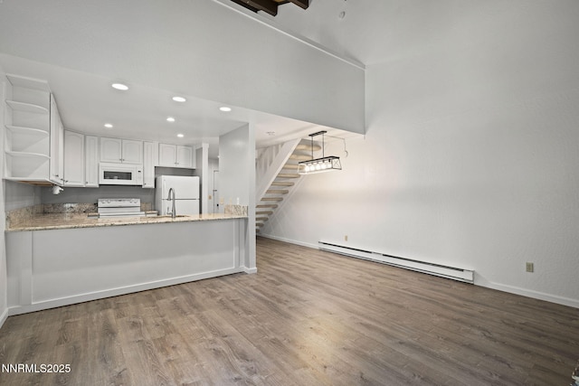 807 Alder Ave Unit 14, Incline Village, NV 89451 - kitchen with white appliances, a baseboard radiator, open shelves, wood finished floors, and white cabinetry