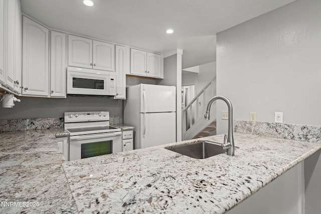 807 Alder Ave Unit 14, Incline Village, NV 89451 - kitchen featuring white appliances, light stone countertops, a peninsula, white cabinets, and recessed lighting