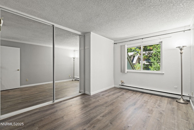 807 Alder Ave Unit 14, Incline Village, NV 89451 - unfurnished bedroom with a baseboard heating unit, wood finished floors, a closet, a textured ceiling, and ornamental molding