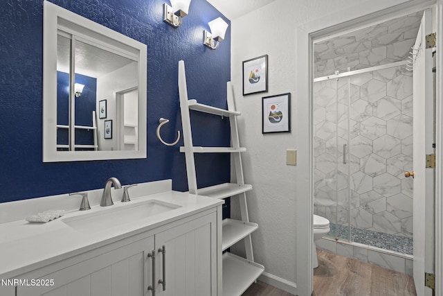 807 Alder Ave Unit 14, Incline Village, NV 89451 - full bathroom with wood finished floors, a shower stall, vanity, and a textured wall