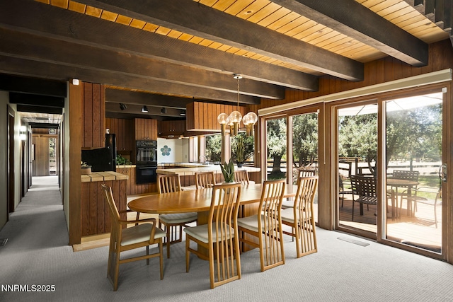 4275 Juniper Creek Rd, Reno, NV 89519 - dining area featuring light carpet, a chandelier, wood walls, and a wood ceiling with exposed beams