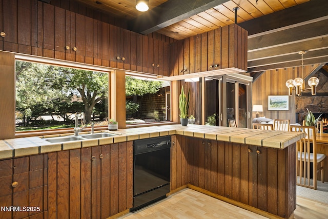 4275 Juniper Creek Rd, Reno, NV 89519 - kitchen with black dishwasher, light wood-style flooring, a wooden ceiling with exposed beams, wooden walls, and tile counters