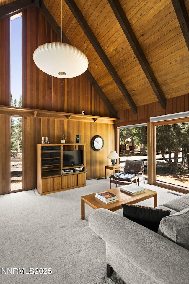 4275 Juniper Creek Rd, Reno, NV 89519 - carpeted living room featuring wood walls, high vaulted ceiling, plenty of natural light, and a wooden ceiling with exposed beams