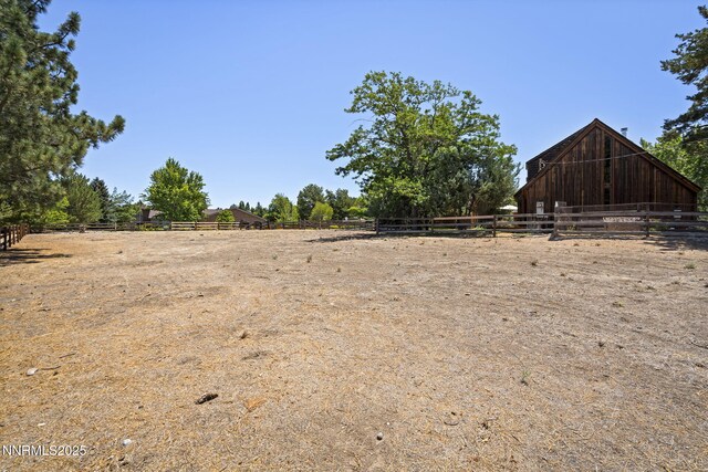 4275 Juniper Creek Rd, Reno, NV 89519 - view of yard featuring an outbuilding, a view of countryside, an outdoor riding arena, and a barn