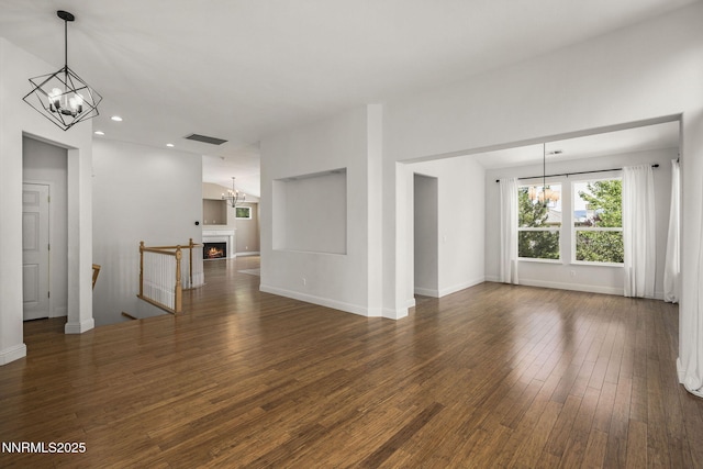 4833 Ramcreek Trl, Reno, NV 89519 - spare room featuring a chandelier, hardwood / wood-style floors, recessed lighting, and a lit fireplace