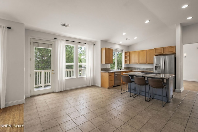 4833 Ramcreek Trl, Reno, NV 89519 - kitchen featuring appliances with stainless steel finishes, open shelves, recessed lighting, a kitchen bar, and a kitchen island