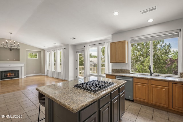 4833 Ramcreek Trl, Reno, NV 89519 - kitchen with appliances with stainless steel finishes, healthy amount of natural light, lofted ceiling, a chandelier, and light tile patterned floors