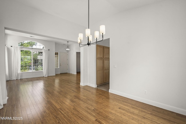 4833 Ramcreek Trl, Reno, NV 89519 - empty room featuring a chandelier, wood finished floors, and high vaulted ceiling