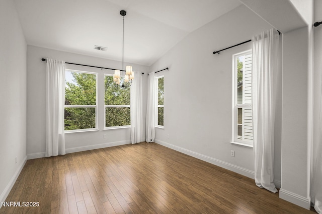 4833 Ramcreek Trl, Reno, NV 89519 - unfurnished dining area featuring a chandelier, healthy amount of natural light, hardwood / wood-style floors, and vaulted ceiling