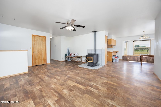 4625 Schurz Hwy, Fallon, NV 89406 - living area with wood finished floors, a wood stove, ceiling fan, and a chandelier
