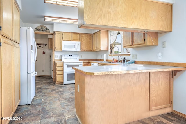 4625 Schurz Hwy, Fallon, NV 89406 - kitchen featuring white appliances, a peninsula, light countertops, and a kitchen breakfast bar