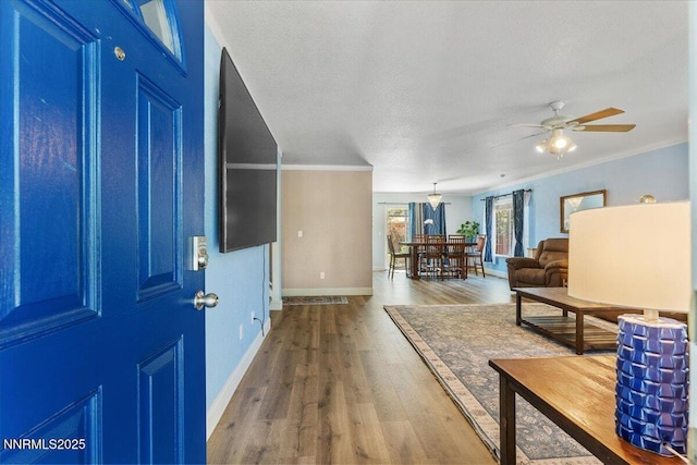18324 Dustin Ct, Reno, NV 89508 - foyer with wood finished floors, a ceiling fan, and crown molding