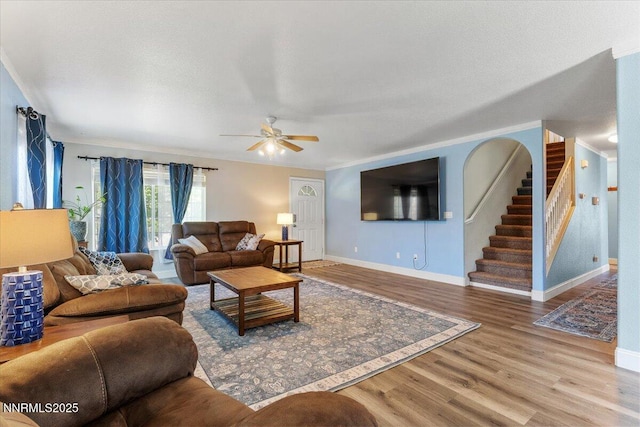 18324 Dustin Ct, Reno, NV 89508 - living room with wood finished floors, a ceiling fan, stairway, and ornamental molding