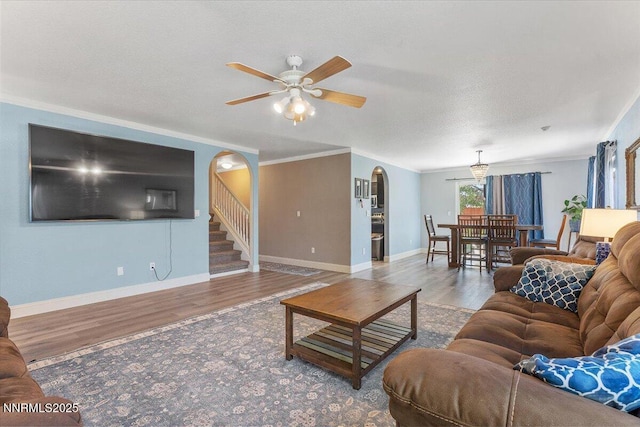 18324 Dustin Ct, Reno, NV 89508 - living room with arched walkways, wood finished floors, crown molding, a ceiling fan, and stairway