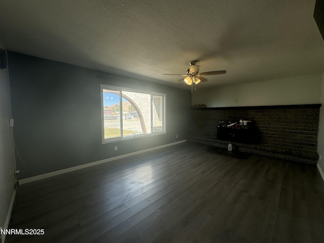 4440 Debra Ln, Winnemucca, NV 89445 - unfurnished living room featuring ceiling fan, dark wood-style floors, and a textured ceiling
