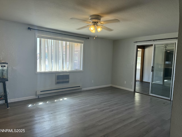 4440 Debra Ln, Winnemucca, NV 89445 - unfurnished room with a baseboard radiator, ceiling fan, dark wood-style floors, a textured ceiling, and an AC wall unit