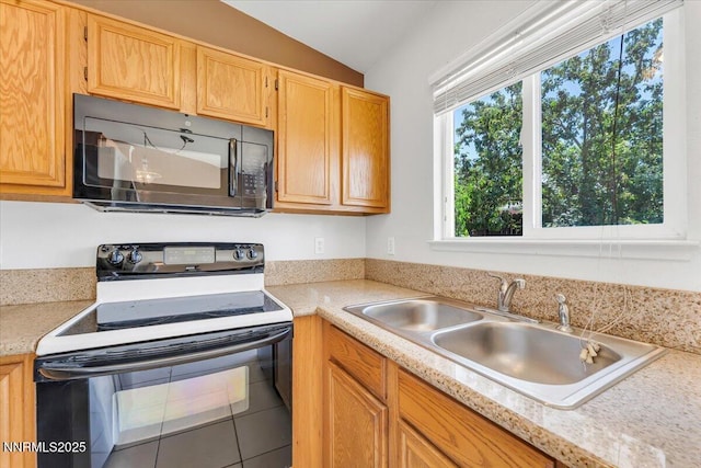 5476 Cabin Ct, Sun Valley, NV 89433 - kitchen with black appliances, light countertops, lofted ceiling, and tile patterned floors
