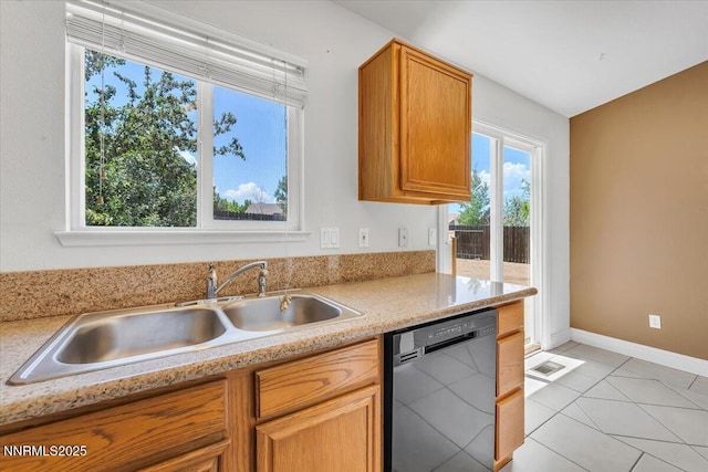 5476 Cabin Ct, Sun Valley, NV 89433 - kitchen with dishwasher, light countertops, brown cabinets, and light tile patterned floors