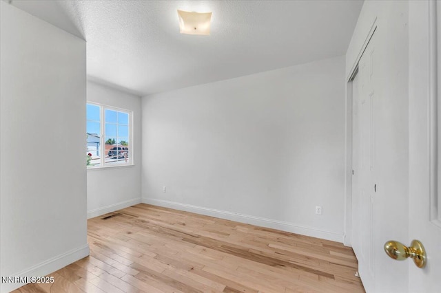 5476 Cabin Ct, Sun Valley, NV 89433 - empty room featuring light wood-style floors and a textured ceiling