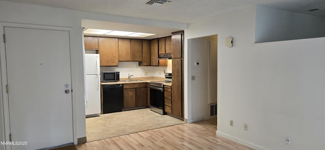 2111 Roundhouse Rd, Sparks, NV 89431 - kitchen with stainless steel appliances, light wood-style floors, extractor fan, and light countertops