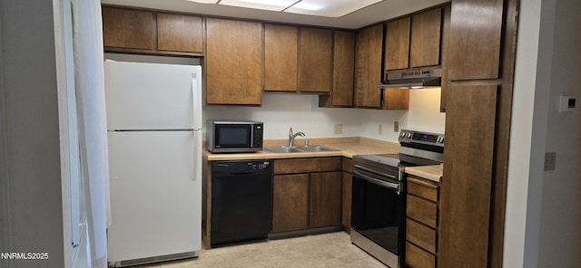 2111 Roundhouse Rd, Sparks, NV 89431 - kitchen featuring freestanding refrigerator, black dishwasher, stainless steel range with electric stovetop, under cabinet range hood, and light countertops
