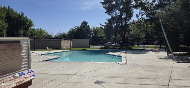 2111 Roundhouse Rd, Sparks, NV 89431 - community pool featuring a patio and view of wooded area