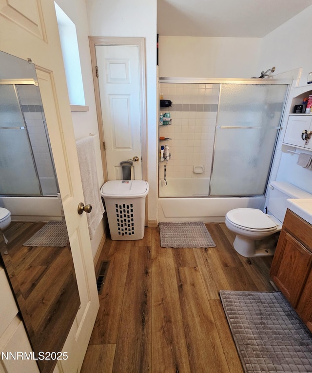 654 Keddie St, Fallon, NV 89406 - bathroom featuring bath / shower combo with glass door, wood finished floors, and vanity