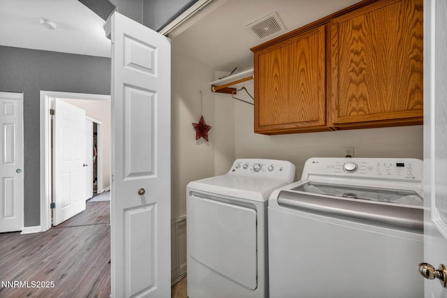 6230 Ingleston Dr Unit 212, Sparks, NV 89436 - washroom with cabinet space, washing machine and dryer, and wood finished floors