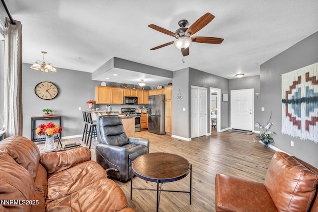 6230 Ingleston Dr Unit 212, Sparks, NV 89436 - living area featuring a ceiling fan, light wood-style floors, and a chandelier