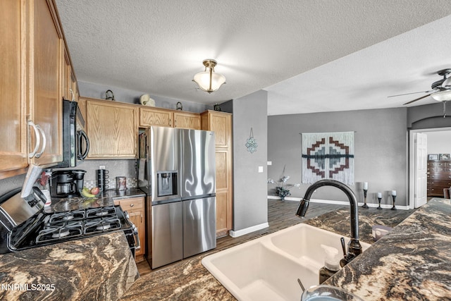 6230 Ingleston Dr Unit 212, Sparks, NV 89436 - kitchen with black appliances, ceiling fan, a textured ceiling, dark wood-type flooring, and dark stone counters