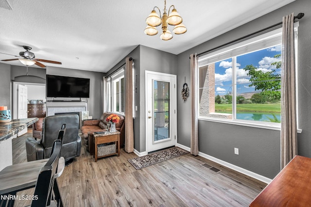6230 Ingleston Dr Unit 212, Sparks, NV 89436 - living room with a chandelier, wood finished floors, and ceiling fan