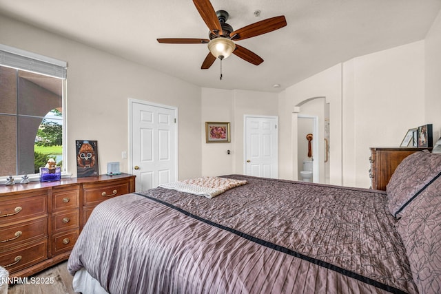 6230 Ingleston Dr Unit 212, Sparks, NV 89436 - bedroom with wood finished floors, arched walkways, ensuite bathroom, and ceiling fan